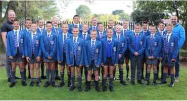a large group of boys in blue school uniforms