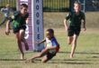 Two teams of young rugby players compete