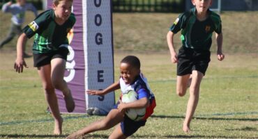 Two teams of young rugby players compete