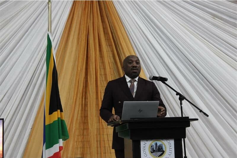 a man stands behind a podium
