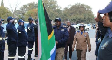 people with an SA flag and an honorary guard