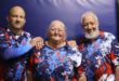 Two men and a woman in blue, red and white sport shirts