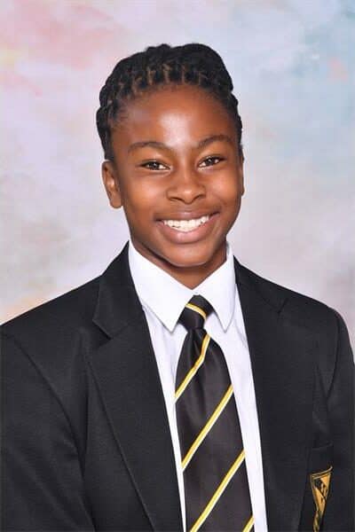 a girl in a school uniform with a black and yellow stripe tie