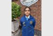 a girl in a blue school uniform