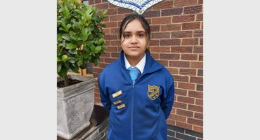 a girl in a blue school uniform