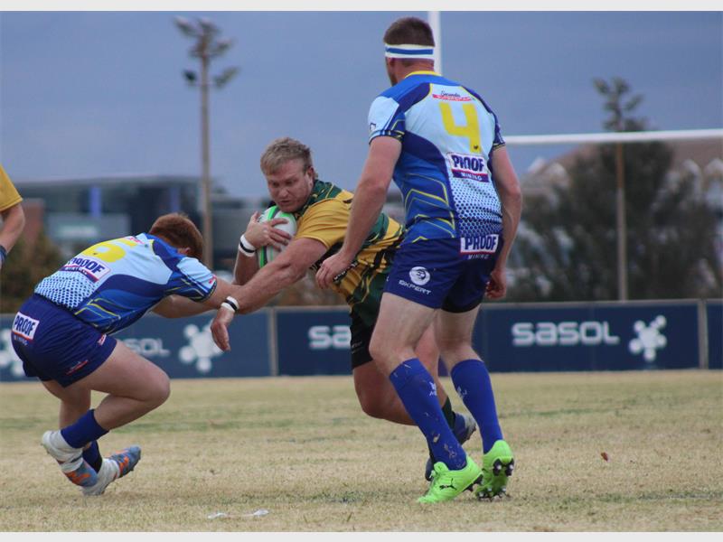 rugby players for two teams compete for the ball