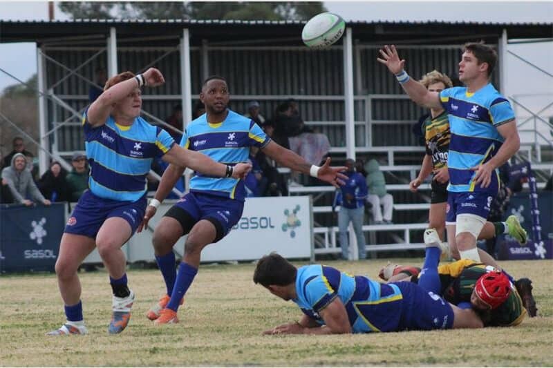 rugby players for two teams compete for the ball