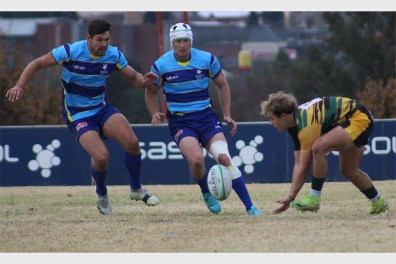 rugby players for two teams compete for the ball
