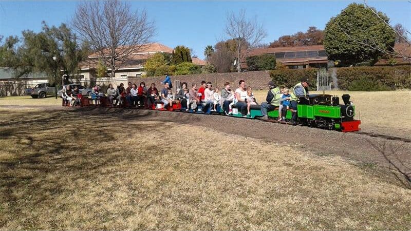 people go for a ride on a miniature steam train