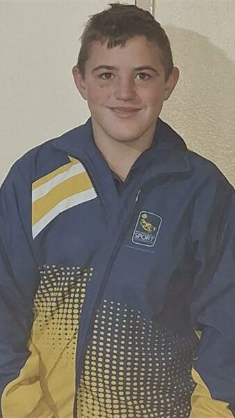 boy in a blue and yellow tracksuit