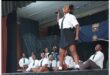 a girl in school uniform on stage