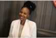 smiling woman wearing a white suit jacket