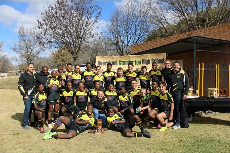 a team of rugby players in yellow and black