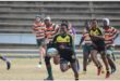 a boy in black and yellow rugby jersey runs at full speed
