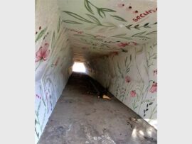 soot marks against a colourful painted tunnel wall