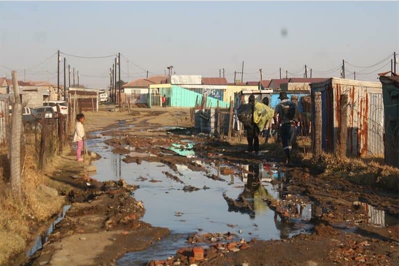 a large sewage spill between shacks