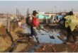 a man steps over a stream of sewage