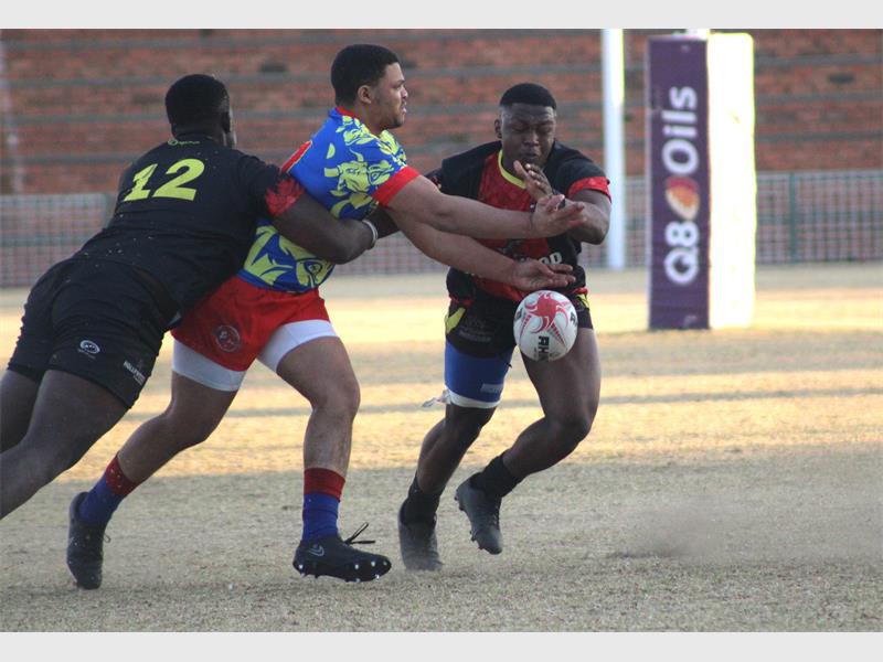 A rugby player gets tackled