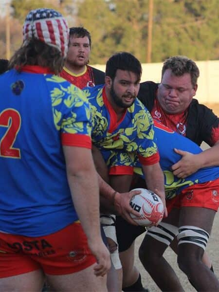 A rugby player gets tackled