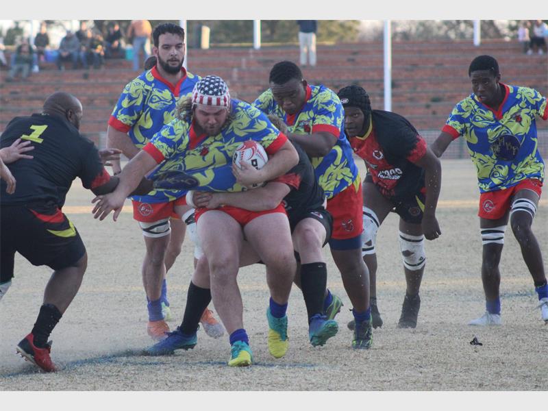 A rugby player gets tackled