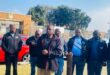 people gather in a group outside a court house