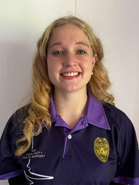 blonde woman in a navy and purple chaplaincy shirt