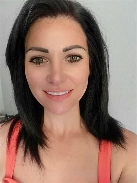 woman with dark hair and orange dress straps over her shoulders