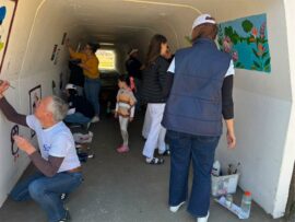 people paint the walls of a tunnel