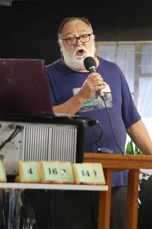 man with grey beard sings