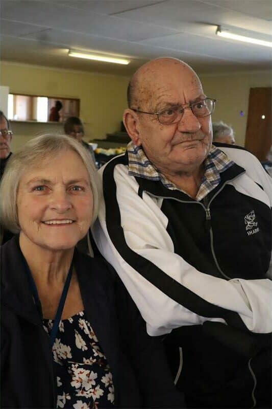 elderly couple smiling at an event