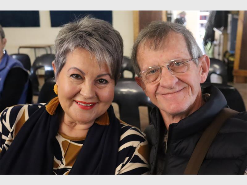 elderly couple smiling at an event