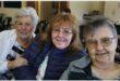 three elderly women sitting next to one another