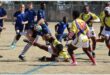 two teams tackle each other on the rugby field