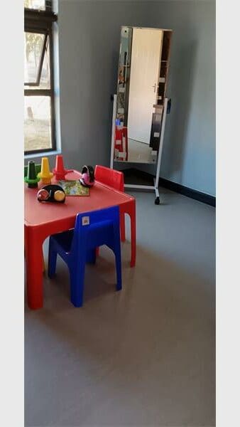 a red table and blue chair for kiddies