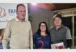 a tall man and two women