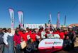 a large group of people in red shirts