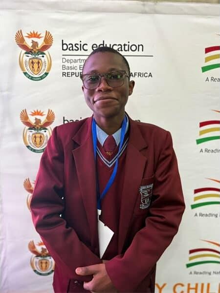 boy in a maroon school uniform
