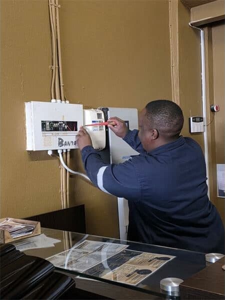 a man tests an electricity meter