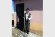 old man sweeps sewage from his house