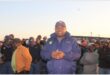 a policeman is surrounded by residents