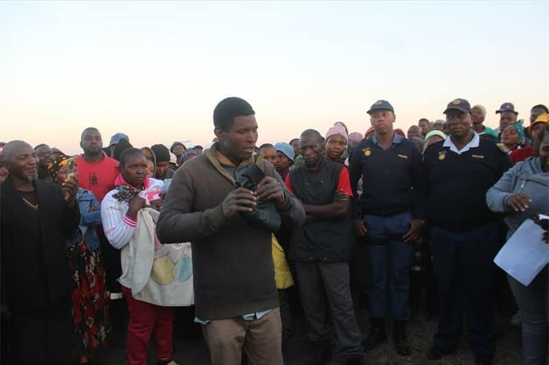 a man speaking in front of a crowd