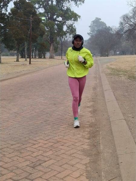 A woman running on a dirt road
