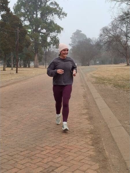 A woman running on a dirt road