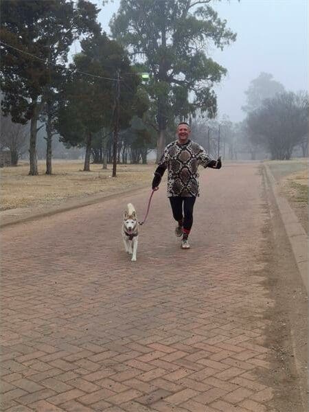 a man running with his dog