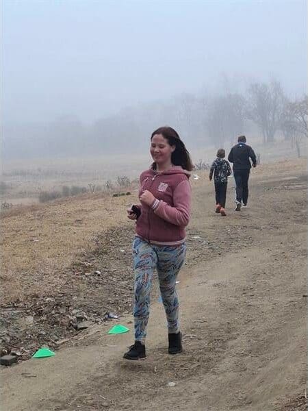 A woman running on a dirt road