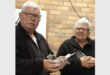 two men with pigeons in their hands