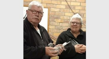 two men with pigeons in their hands