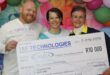 three people hold up a large check of R10 000