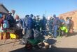 people are working outside with wheelbarrows and back bags
