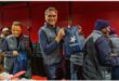 a man with sasol logo holds up a bag